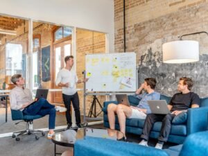 Startup team meeting with laptops and Kanban board - starting social media from zero followers Content-Disposition: form-data; name="caption" Startup team meeting with laptops and Kanban board - starting social media from zero followers