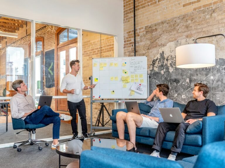 Startup team meeting with laptops and Kanban board - starting social media from zero followers Content-Disposition: form-data; name="caption" Startup team meeting with laptops and Kanban board - starting social media from zero followers
