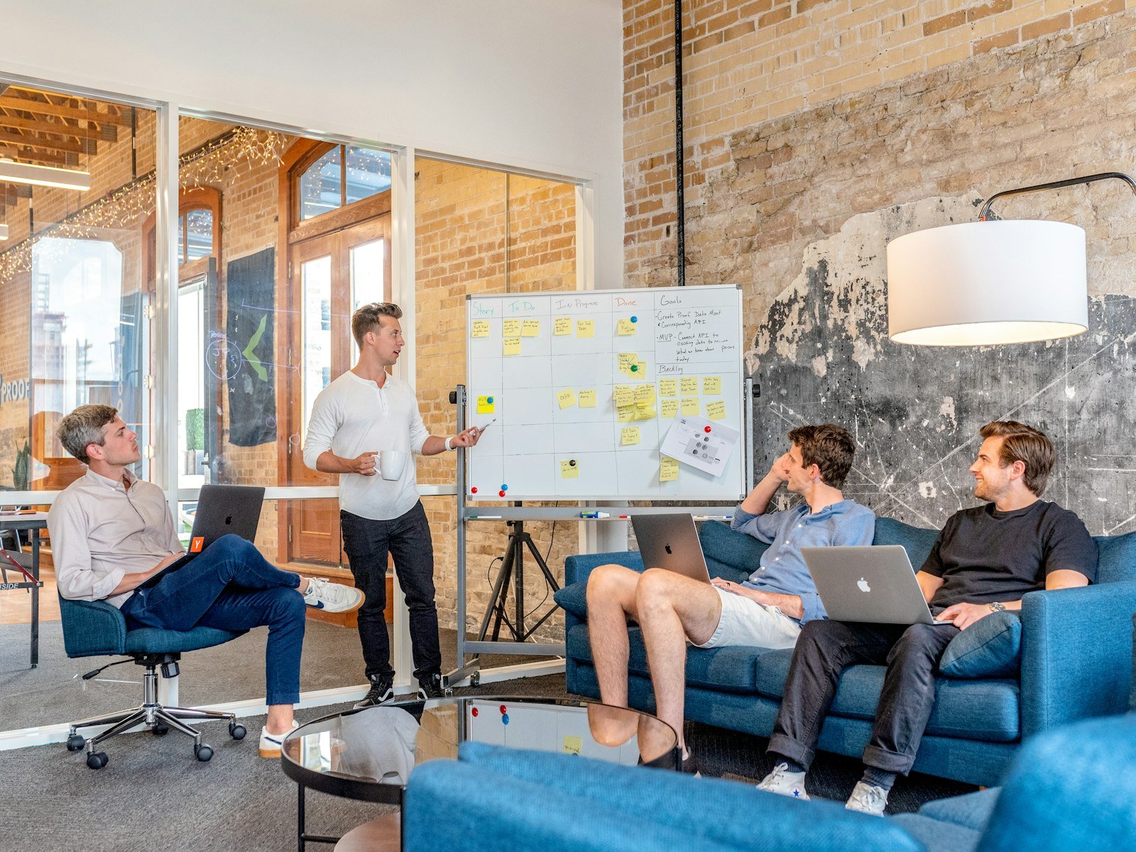 Startup team meeting with laptops and Kanban board - starting social media from zero followers Content-Disposition: form-data; name="caption" Startup team meeting with laptops and Kanban board - starting social media from zero followers