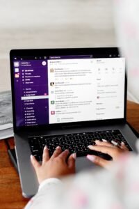 Person using laptop with Slack social media channel - Facebook ad copywriting context Content-Disposition: form-data; name="caption" Person using laptop with Slack social media channel - Facebook ad copywriting context